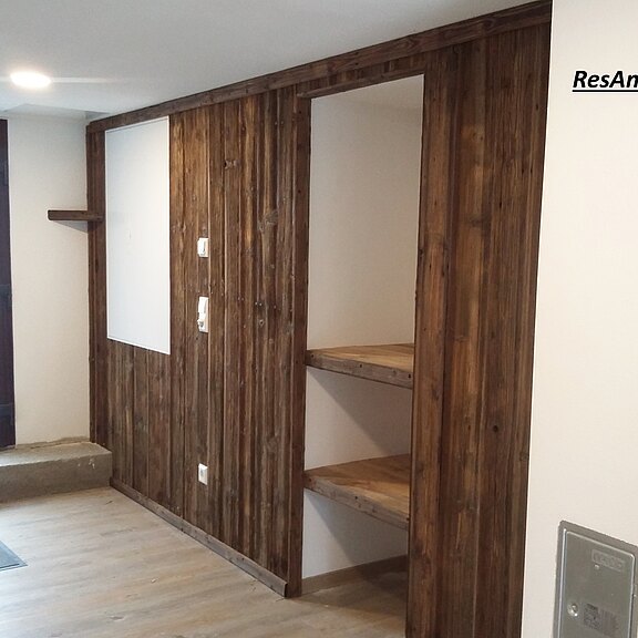 Wandverkleidung mit gebuersteten Altholzbrettern Wandverkleidung mit braunen Altholzbrettern